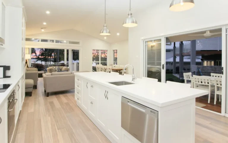 a kitchen and living room with a couch and a large window